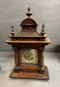 A German carved oak eight day mantel bracket clock possibly by Junghans