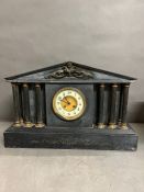 A Victorian black marble mantle clock flanked with five pillars and inlay