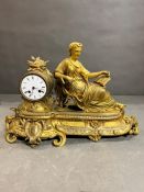 A classical gilt mantel clock with figure of a lady with a book, French