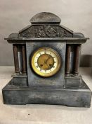 A French black slate striking mantle clock on raised mount and Corinthian columns