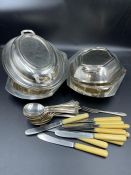 A selection of cutlery and some plated serving dishes