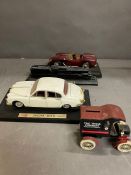 Four model cars and a train