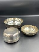 A selection of three white metal bowls