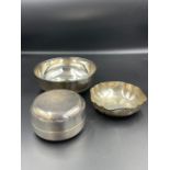 A selection of three white metal bowls