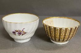 A gilded Worcester tea bowl and a Worcester 1800-1809 tea bowl