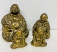 A selection of four brass buddha various sizes