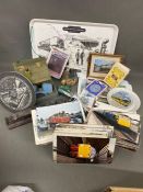 A large selection of various railway collectables, clock, model of train, postcards, mats, playing