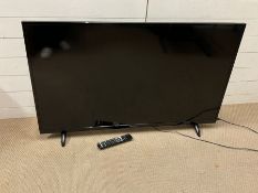 A 50 inch Techwood model 55A064USB TV with remote