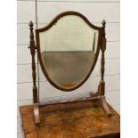 A shield dressing table mirror on turned supports