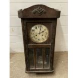 An oak cased wall clock