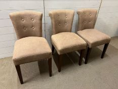 Three stone coloured dining chairs with handle to back