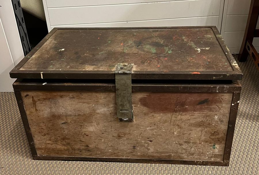 A wooden and metal bound trunk (H34cm W68cm D44cm)
