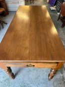 A large farmhouse oak table with turned legs and drawers to each end (H78cm W200cm D84cm)
