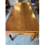 A large farmhouse oak table with turned legs and drawers to each end (H78cm W200cm D84cm)