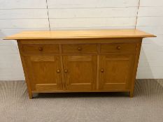 An oak sideboard by Marks and Spencer's, three drawers with three cupboards below