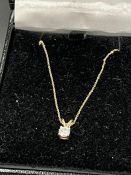 A 9ct gold and 20pts diamond pendant and fine chain.