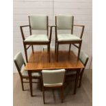 A Mid Century Gordan Russell extending dining table and six chairs (H77cm W108cm D78cm)