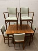 A Mid Century Gordan Russell extending dining table and six chairs (H77cm W108cm D78cm)
