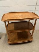 An Ercol blonde three tier trolley