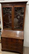 George III style bureau bookcase, a pair of astragal glazed doors opening to shelves the lower