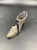 A Victorian shoe shaped pin cushion