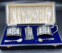 A silver cruet set by A Chick & Sons Ltd all with blue glass liners, hallmarked for 1974