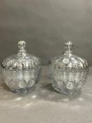 A pair of decorated glass lidded pots