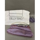 A purple satin clutch bag by Billy