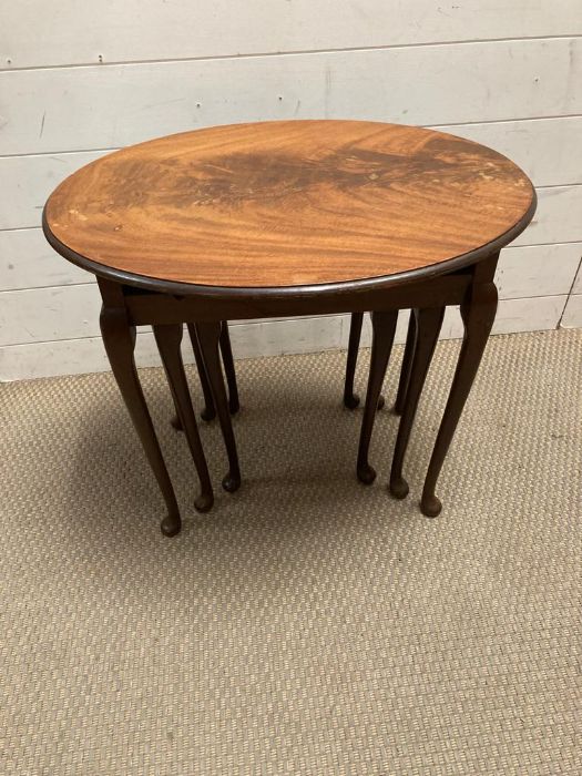 A nest of three oval tables on pad feet. - Image 2 of 2