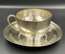 A silver tea cup and saucer (Approximate weight 190g)
