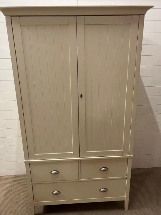 A double wardrobe with drawers under (H196cm W113cm D64cm)