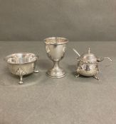 A silver egg cup, mustard with blue glass liner and a silver cruet, various hallmarks and makers.