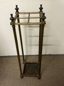 A brass umbrella or stick stand with four compartments