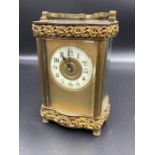 A French enamel faced and ornate brass carriage clock
