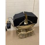 An 1950's double hood pram (H93cm W103cm D39cm)