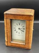 A Goldsmiths and Silversmiths carriage clock in travel case (missing glass to top)