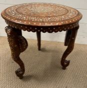 An inlaid Indian table with carved elephant trunk legs (H40cm Dia40cm)