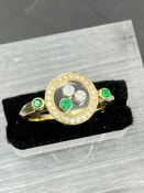 A Contemporary ring with floating diamonds and emeralds (Approximate Size N 1/2)