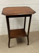 A mahogany side table with shelf under