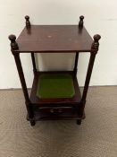 A two tier side table with four supports and drawer to base