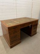 A large Victorian style mahogany pedestal desk with brass swan handles and leather top (H80cm W152cm