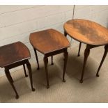 A nest of three oval tables on pad feet.
