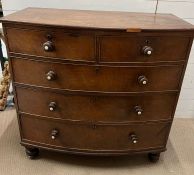 A mahogany chest of drawers on bun feet (H103cm W106cm D54cm)