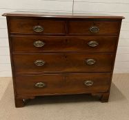 A two over three chest of drawers with brass handles on bracket feet (H98cm W111cm D56cm)