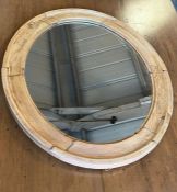 An oval pine wall mirror (62cm x 52cm)