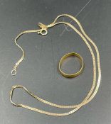 A 9ct gold necklace (3g) and a 22ct gold wedding band (2g)