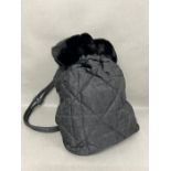 A Lady Dior cloth backpack by Dior Monogram fabric with faux fur edge and silver hardware Dior