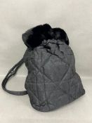 A Lady Dior cloth backpack by Dior Monogram fabric with faux fur edge and silver hardware Dior