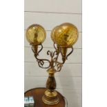 1960's lamp with three brass arms with glass sphere shades and painting hunting scene to base AF
