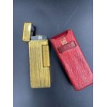 A Vintage Dunhill lighter in original red leather holder.